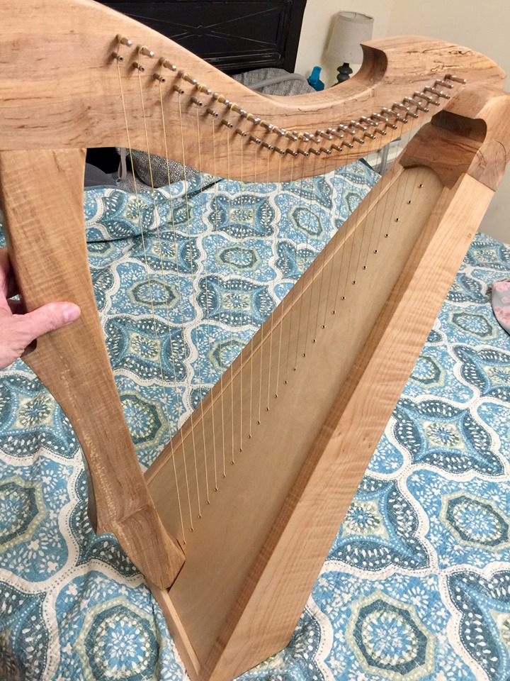 A stunning curly walnut Irish harp.